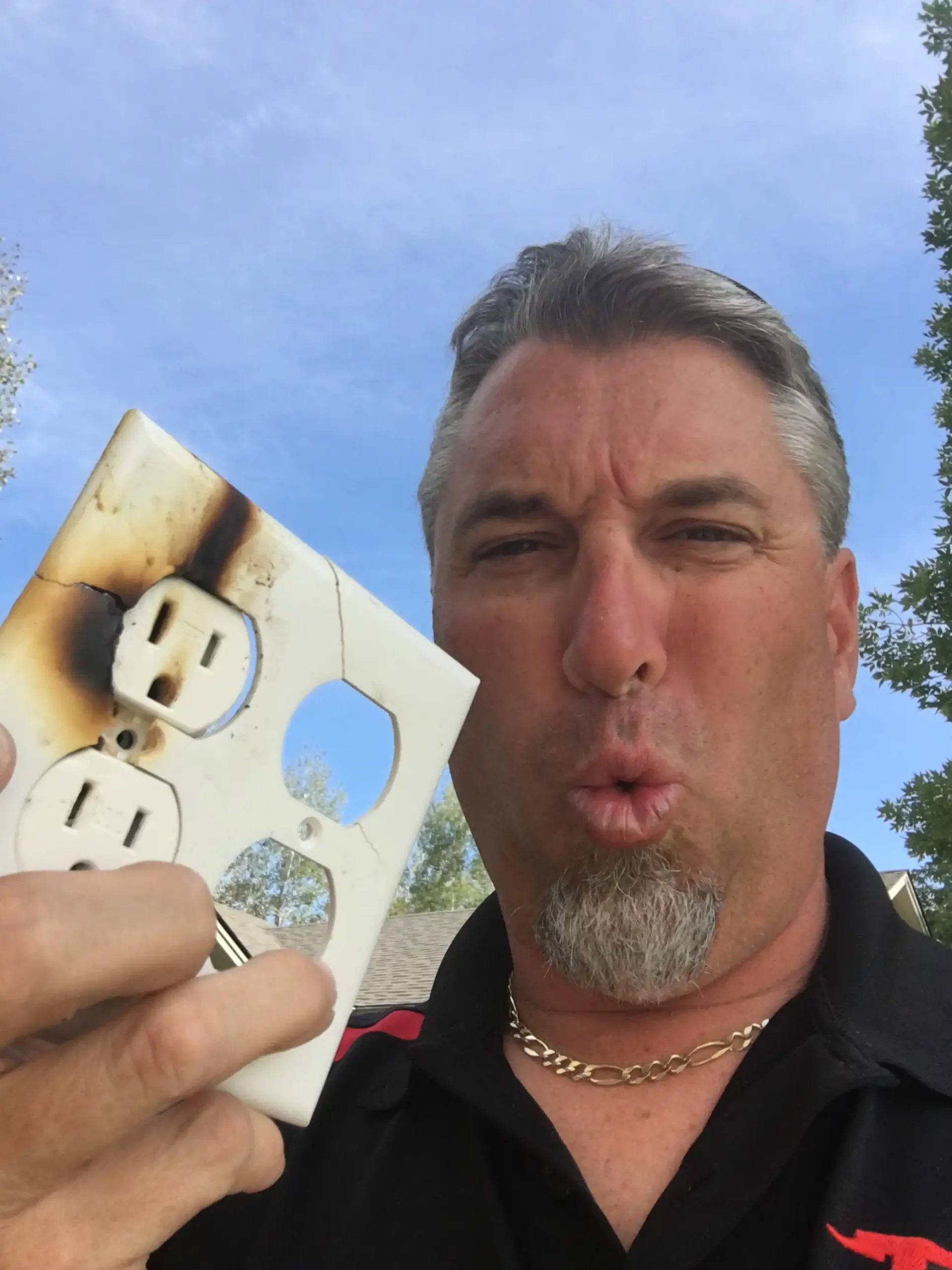 Titus employee holding a burnt outlet